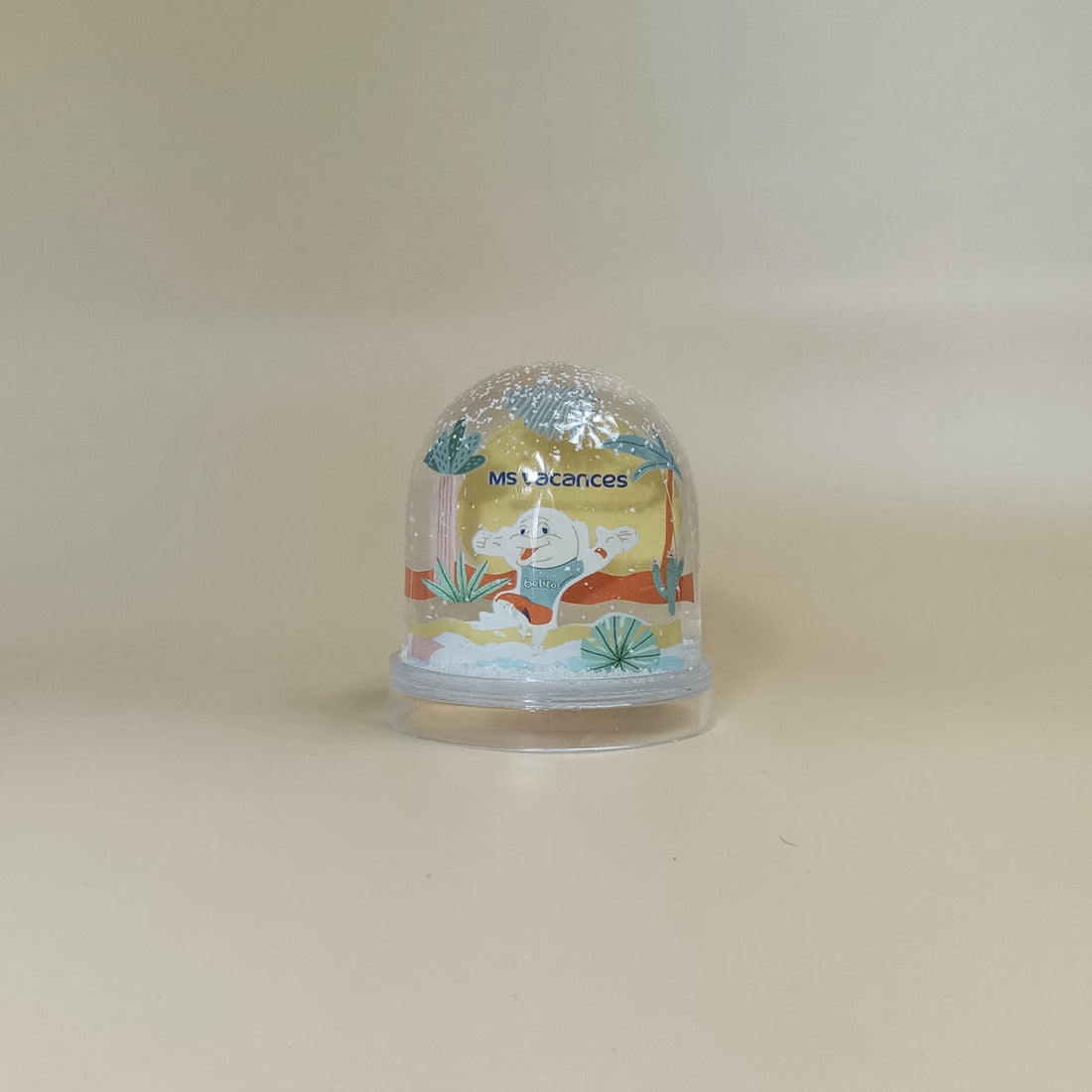 Boule à neige MS Vacances avec mascotte dans un décor tropical